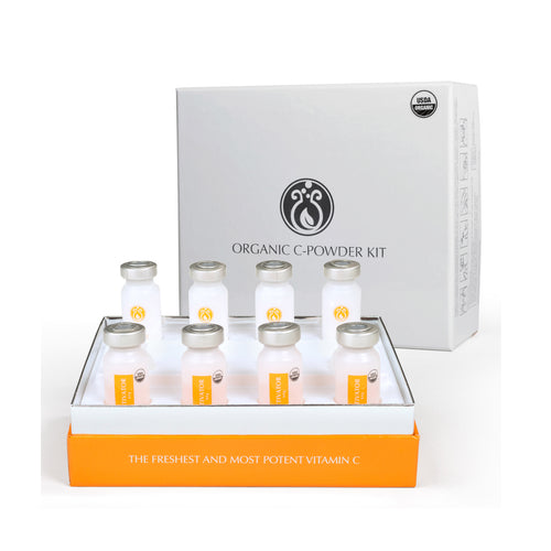A product image featuring a white box labeled 'ORGANIC C-POWDER KIT' with multiple small glass vials inside. The vials are labeled with dates, and the box has a USDA Organic symbol.