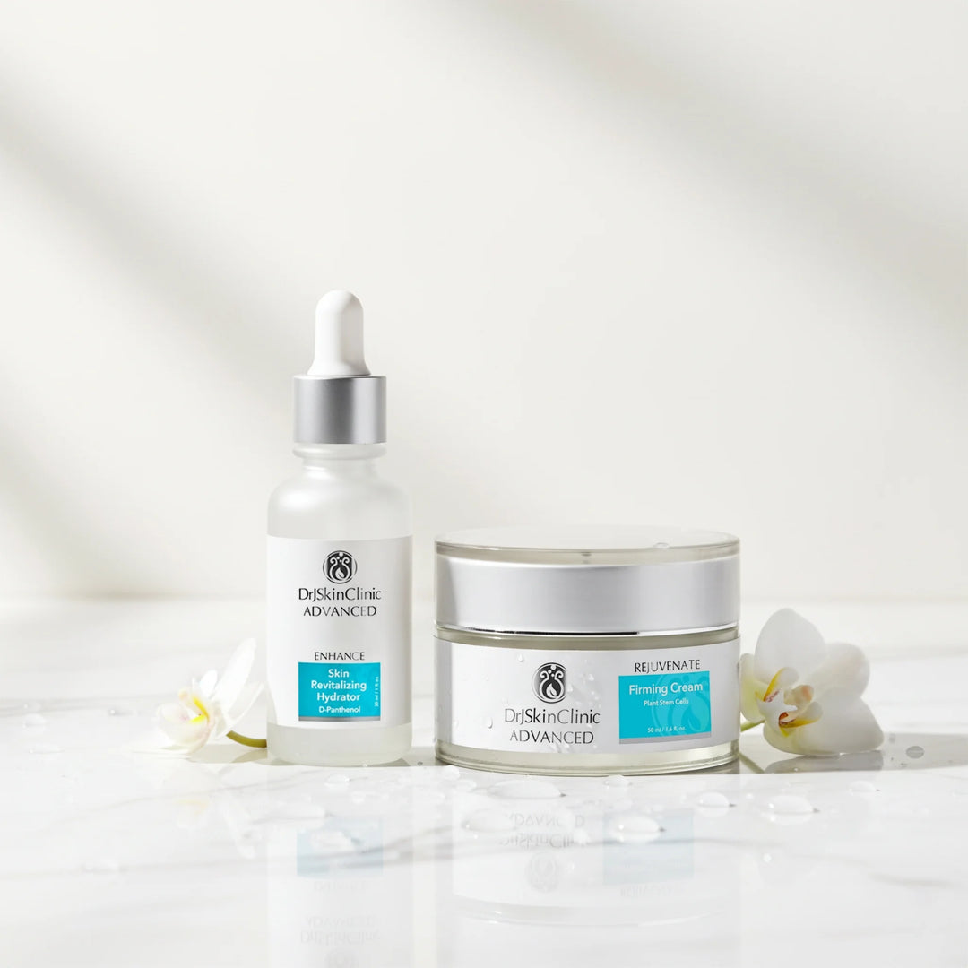 DrSkinClinic Advanced Firm + Hydrate Duo featuring Skin Revitalizing Hydrator and Rejuvenate Firming Cream displayed with white flowers and water droplets.