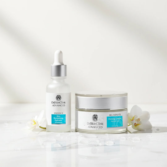 DrSkinClinic Advanced Firm + Hydrate Duo featuring Skin Revitalizing Hydrator and Rejuvenate Firming Cream displayed with white flowers and water droplets.