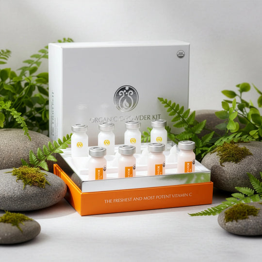Organic Vitamin C product set with bottles and packaging on a natural stone and plant background